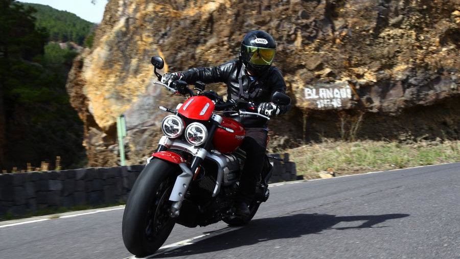 A red 2020 Triumph Rocket 3 being ridden on a road